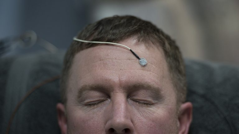 A man hooked up to neurofeedback electrodes.