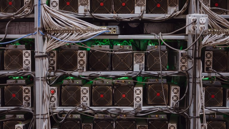 Bitcoin mining machines in a warehouse.