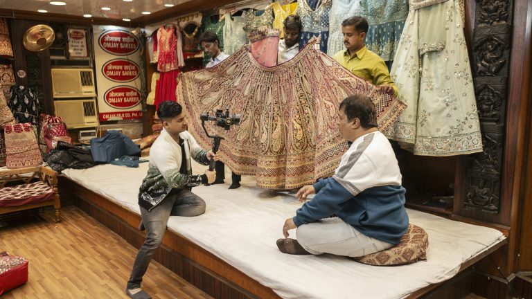People filming a video at a wedding shop in India.