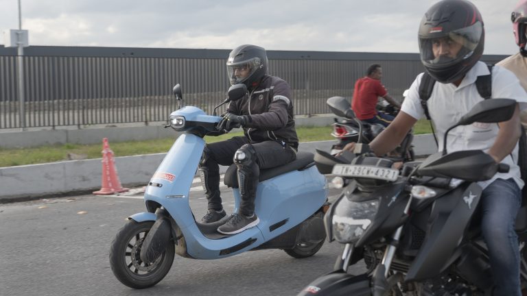 An Ola electric scooter (in Blue) is tested by a rider in Pochampalli, India.