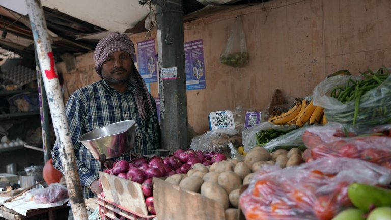 A food vendor with Paytm and PhonePe sound boxes in India.