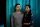 A portrait photo of Urban Company employee Renu Roy and her husband, taken indoors in front of a curtain.