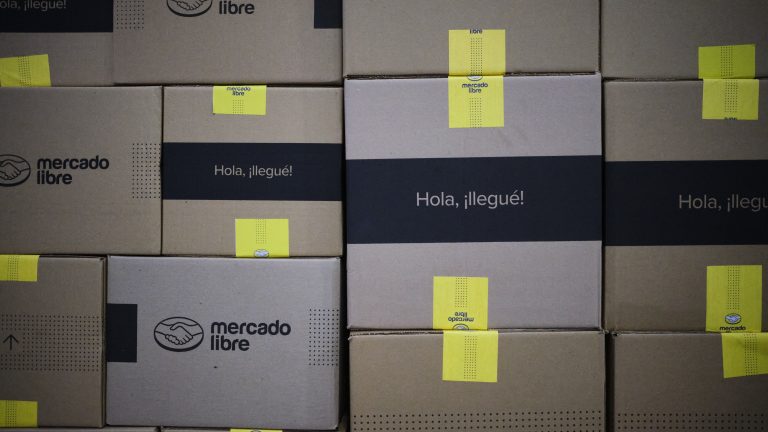 A photo of a stack of cardboard shipping boxes with Mercado Libre labels.