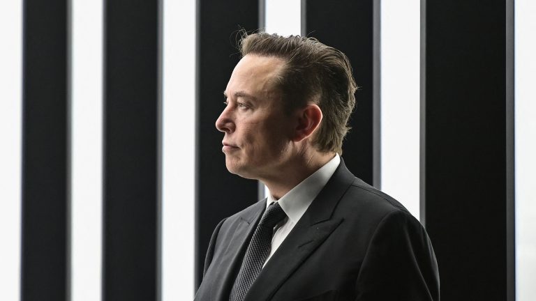 A picture of Elon Musk in a black suit.