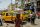 A woman carrying items with a tray on her head walked through a busy street in Lagos, Nigeria.