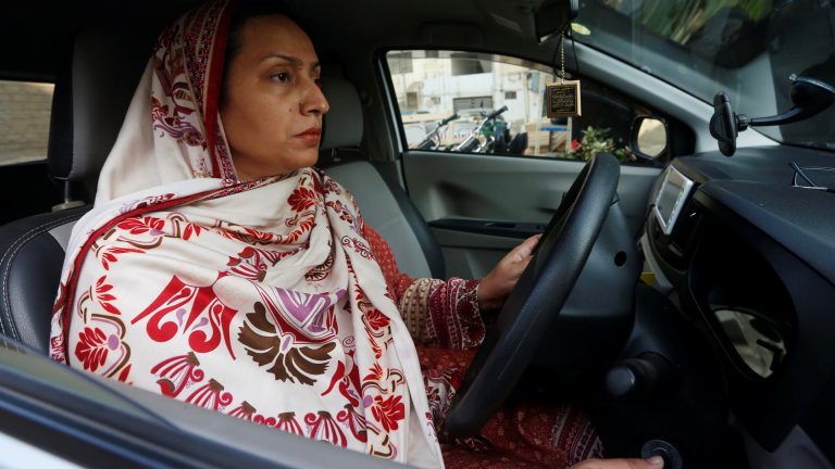 A photo of a woman driving a car in Pakistan.