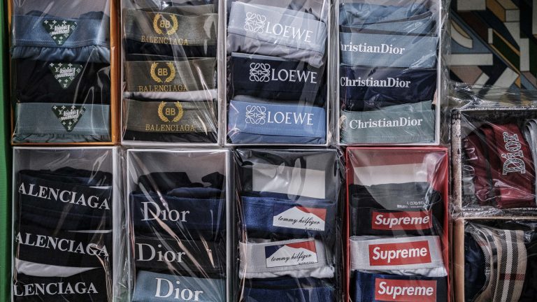 A photo of many boxes of folder underwear on shelves in a store, with logos from popular clothing brands.