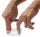 A pair of hands pull open a small, transparent plastic object. It looks like a very small plastic bag with an elasticated rim.