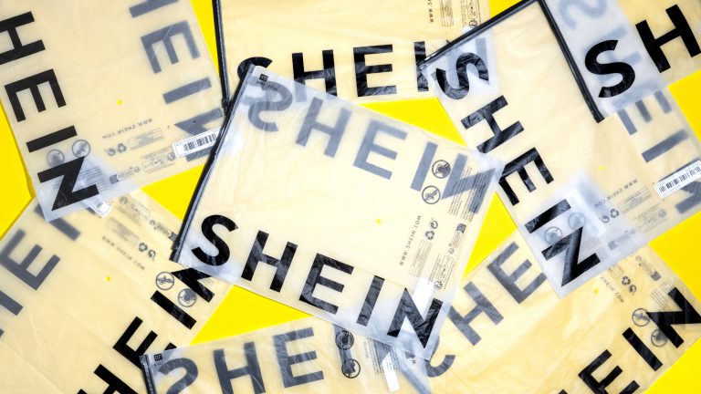 A photo showing a cluster of Shein shipping bags laid out on a yellow background.