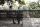 Photo of a man and woman having a conversation on an outdoor bench