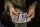 A photograph showing a woman's hands displaying a set of playing cards.